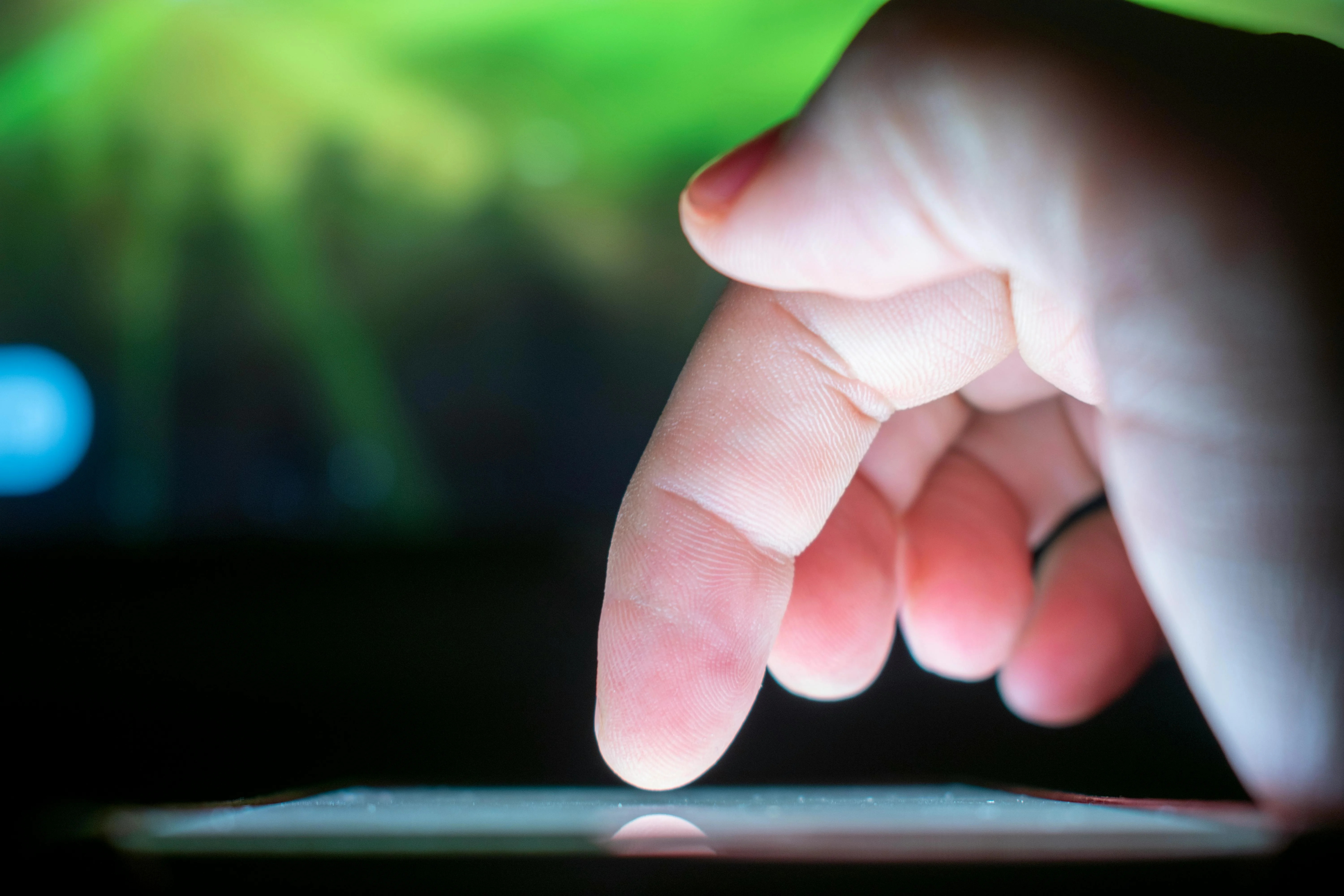 Close-up of finger tapping a CTA button on a mobile link-in-bio page with visible tracking pixels and analytics overlay
